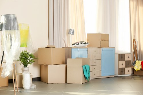 Furniture pick-up team handling bulky items in a Hoxton residential street