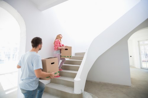 Professional movers handling furniture in a Hoxton flat